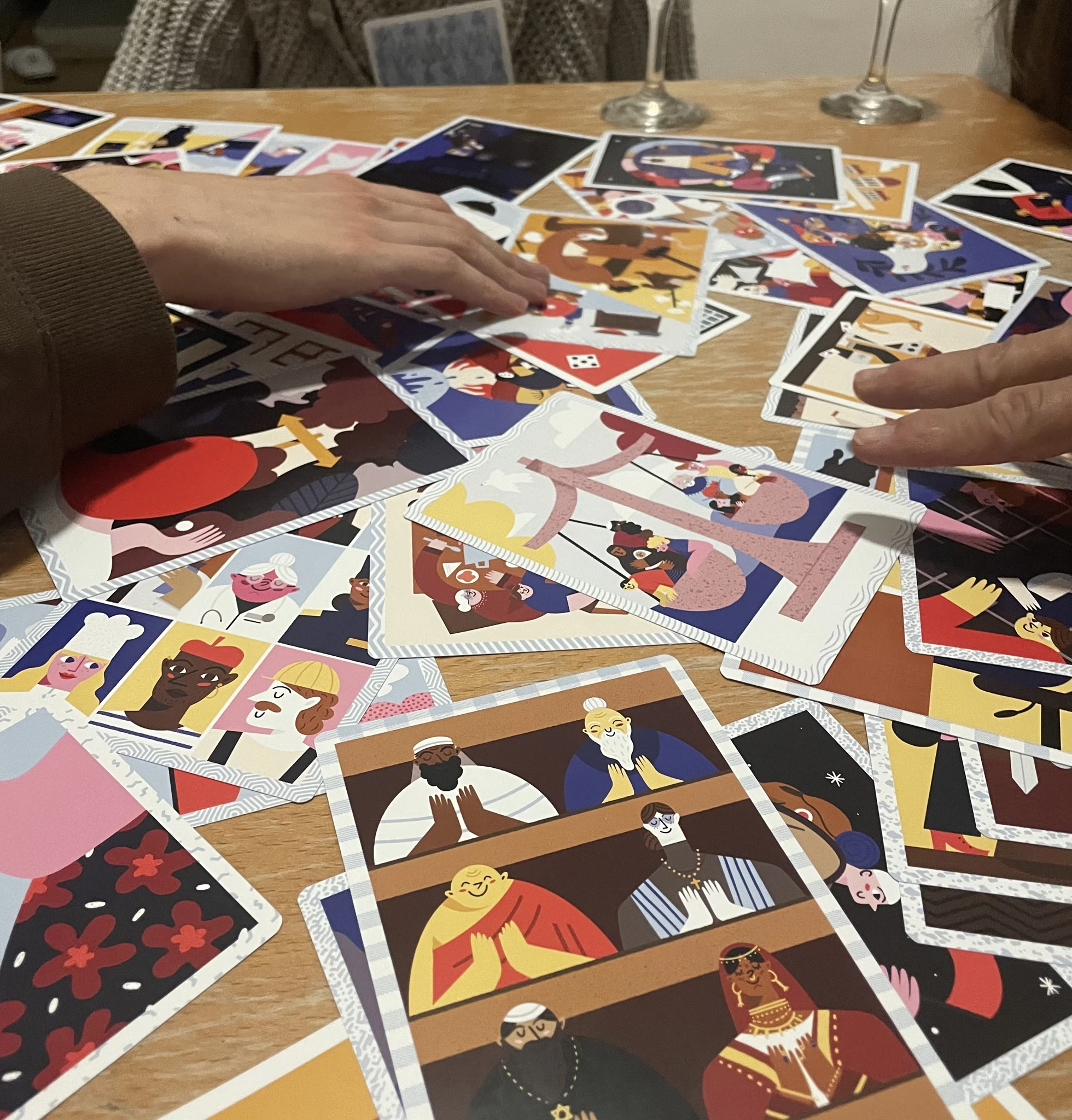 KIO card game showing beautiful illustrated cards with human rights themes